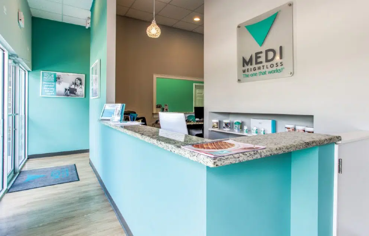 Teal and white modern medical weight loss clinic reception desk with granite countertop