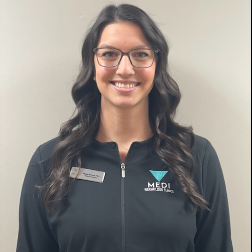 Smiling female medical professional wearing glasses and MEDI branded jacket